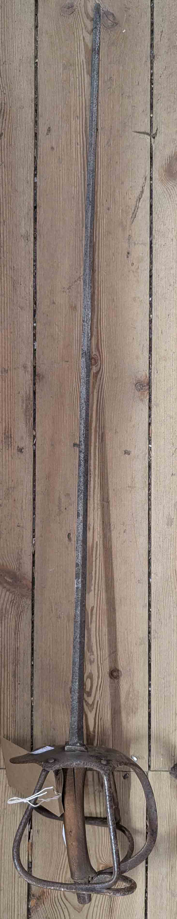 An antique sword with metal cage handguard and wood hilt