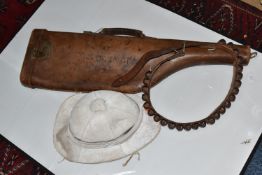 A PITH HELMET, LEATHER GUN CASE, AND BANDOLIER to include a well-worn pith helmet (signs of insect