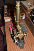 A MICROSCOPE, a brass and cast metal microscope, stamped 'R. Field & Son, Opticians, New Street,