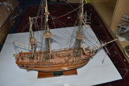 A WOODEN KIT BUILT MODEL SHIP OF HMS BOUNTY with rigging and miniature sailors, display present on