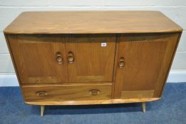 LUCIAN ERCOLANI, ERCOL, A MID CENTURY ELM AND BEECH SIDEBOARD, fitted with three cupboard doors