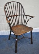 A YEW WOOD WINDSOR HOOP BACK CHAIR, the spindles terminate to shaped armrests, an elm dished seat,