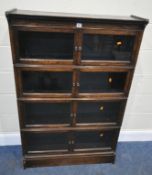 W M BAKER AND CO, OXFORD, AN EARLY 20TH CENTURY OAK FOUR SECTION ELASTIC BOOKCASE, each section with