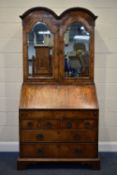 A QUEEN ANNE (CIRCA 1710) FIGURED WALNUT DOUBLE DOME TOP BUREAU BOOKCASE, the double bevelled edge