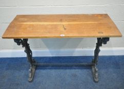 A GREY PAINTED CAST IRON TABLE, with scrolled and mask details, and a later top surface, width 107cm
