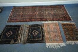 A RED AND BLUE GROUND CARPET RUNNER, with repeating geometric patterns, surrounded by a multi-