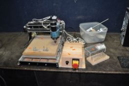 A CNC MILLING/ENGRAVING MACHINE, with a 25cm x 25cm working area, power cable (attached), power
