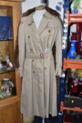 A LADIES' BURBERRY'S TRENCHCOAT, lined with traditional Burberry Nova check, size 12/14, length