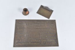 A BRASS MILITARY PLAQUE AND TWO SMALL PIECES OF TRENCH ART, the plaque would have been attached to a