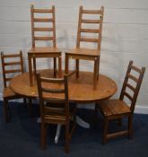 A MODERN STAINED PINE AND PAINTED OVAL KITCHEN PEDESTAL TABLE, with a single drawer, extended length