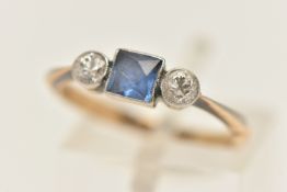 A THREE STONE RING, principally set with a square cut sapphire bezel set in white metal with