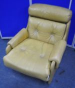 A MID-CENTURY TANNED LEATHER ARMCHAIR, the rubber webbing under the seat pad reading 'Pirelli Ltd'