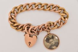 A 9CT GOLD BRACELET, a large hollow curb link chain bracelet with textured detail to some of the