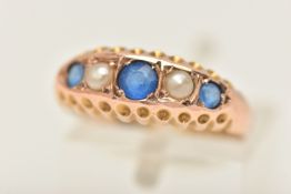 A 9CT GOLD BOAT RING, set with three circular cut blue paste stones and two seed pearls, prong set