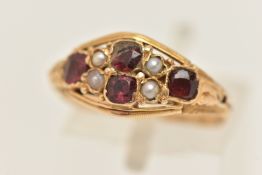 AN EARLY 20TH CENTURY 15CT GOLD GEM SET RING, set with four circular cut garnets (one garnet is
