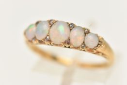 A YELLOW METAL OPAL SET RING, set with five oval cut opal cabochons, each in a claw setting with