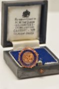 A 9CT GOLD AND ENAMEL BADGE, blue enamel inscribed 'The Blue Circle Group Of Companies' number 35,