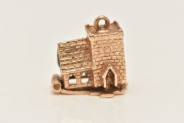 A YELLOW METAL STANHOPE CHURCH CHARM, unmarked, hinged opening reveals bride and groom, adhesive and