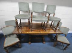 AN EARLY 20TH CENTURY OAK DRAW LEAF DINING TABLE, raised on bulbous legs, united by a stretcher,