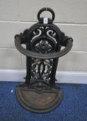 A CAST IRON DEMI-LUNE STICK STAND, with repeating foliate designs, height 74cm (condition report: