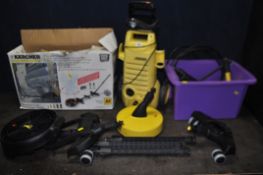 A KARCHER 2.950 PRESSURE WASHER, with a box of accessories including a patio cleaner, brushes, and