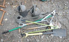 THREE GALVANISED WATERING CANS, along with a quantity of gardening tools, to include spades,