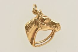 A YELLOW METAL EQUESTRIAN PENDANT, a yellow metal horse head, unclear continental stamps,