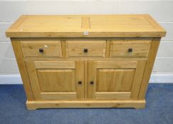 A MODERN SOLID OAK SIDEBOARD, fitted with three drawers over double cupboard door, width 130cm x