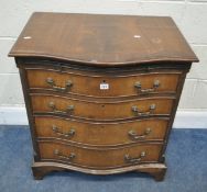 AN EARLY 20TH CENTURY MAHOGANY SERPENTINE CHEST OF FOUR GRADUATED DRAWERS, and a brushing slide