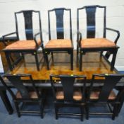 AN ORIENTAL HARDWOOD AND EBONISED EXTENDING DINING TABLE, with two additional leaves, extended