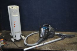 A HOOVER BREEZE VACUUM CLEANER, a numatic Henry vacuum cleaner, missing part of metal hose