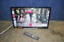 A TOSHIBA 24W38630D 24in SMART TV with remote and wall bracket fitted (no stand) and a Toshiba