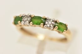 A 9CT GOLD GARNET AND DIAMOND HALF ETERNITY RING, set with three oval cut green garnets, interspaced