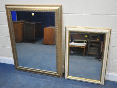 A LARGE RECTANGULAR BEVELLED EDGE WALL MIRROR, 122cm x 96cm, along with a smaller foliate frame