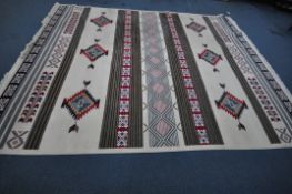 MARGAN A LARGE CREAM GROUND RECTANGULAR RUG, with repeating geometric patterns, 396cm x 300cm,