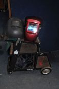 A CLARKE GWC1 WHEELED WELDER STAND with two masks (3)