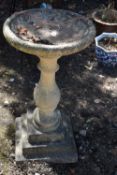 A COMPOSITE BIRD BATH, on a shaped support and a stepped base, diameter 48cm x height 87cm,