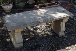 A COMPOSITE RECTANGULAR GARDEN BENCH, on twin scrolled ends, length 109cm, condition report: some