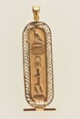 A YELLOW METAL EGYPTIAN CARTOUCHE PENDANT, oval form pendant with hieroglyphics, approximate