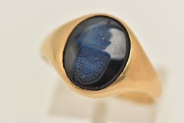 AN 18CT GOLD AND SAPPHIRE SIGNET RING, an oval cut sapphire intaglio seal, collet set in yellow