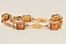 A YELLOW METAL CITRINE LINE BRACELET, designed as a series of five rectangular cut Citrine's in four