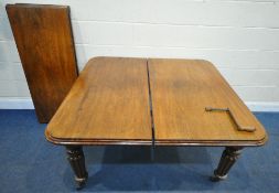 A VICTORIAN MAHOGANY WIND OUT DINING TABLE, with two additional leaves, raised on fluted and tapered