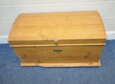 A PINE DOMED TRUNK, with a candle box and twin metal handles, width 100cm x depth 46cm x height