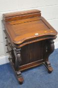 A REPRODUCTION HARDWOOD DAVENPORT: with a lidded storage compartment, a hinged surface, shaped