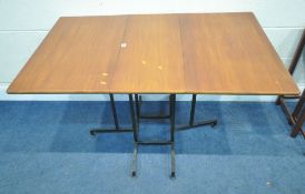 POSSIBLY STAPLES LADDERAX, A MID-CENTURY TEAK GATE LEG TABLE, raised on tubular metal legs, open