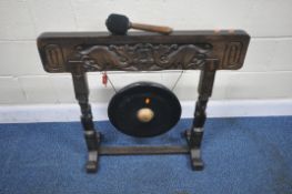 A LATE 20TH CENTURY FLOOR STANDING DINNER GONG, with geometric details, and humanoid supports,