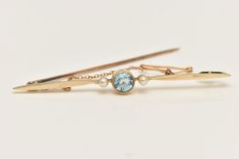 AN EARLY 20TH CENTURY PROPELLOR BAR BROOCH, centrally collet set with a circular cut blue aquamarine