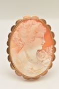 A 9CT GOLD CAMEO BROOCH, a large shell cameo depicting the portrait of a lady and floral detail,