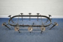 A CAST IRON OVAL MEDIEVAL STYLE CHANDELIER, hanging from chains, with ten branches, length 203cm x