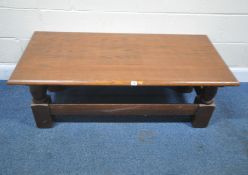 A SOLID OAK RECTANGULAR COFFEE TABLE, raised on block and turned legs, united by stretchers, width